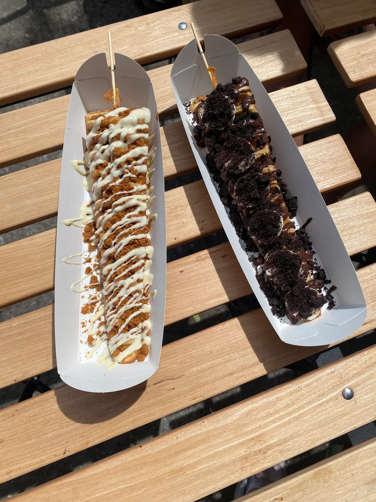 Two BrewBerry loaded waffles, one with Biscoff crumbs and one with Oreo crumbs