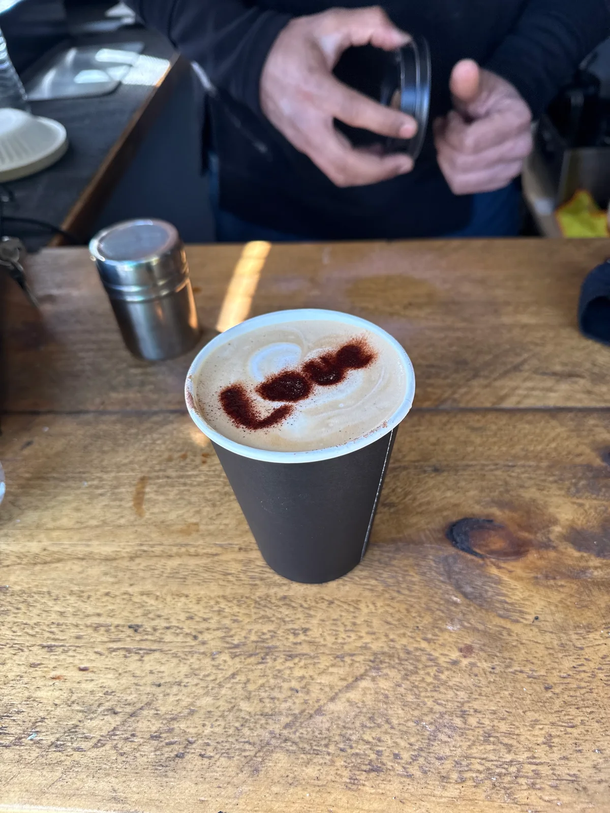 A freshly served coffee on BrewBerry's wooden counter